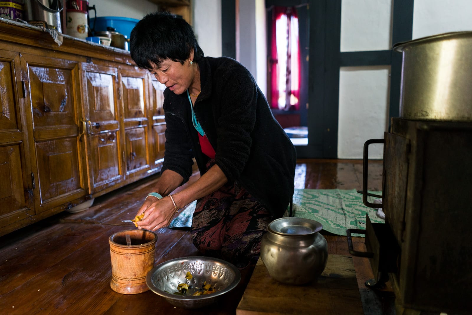 Photos of Bhutan - Homestay host in Phobjikha Valley cutting up chilies - Lost With Purpose travel blog