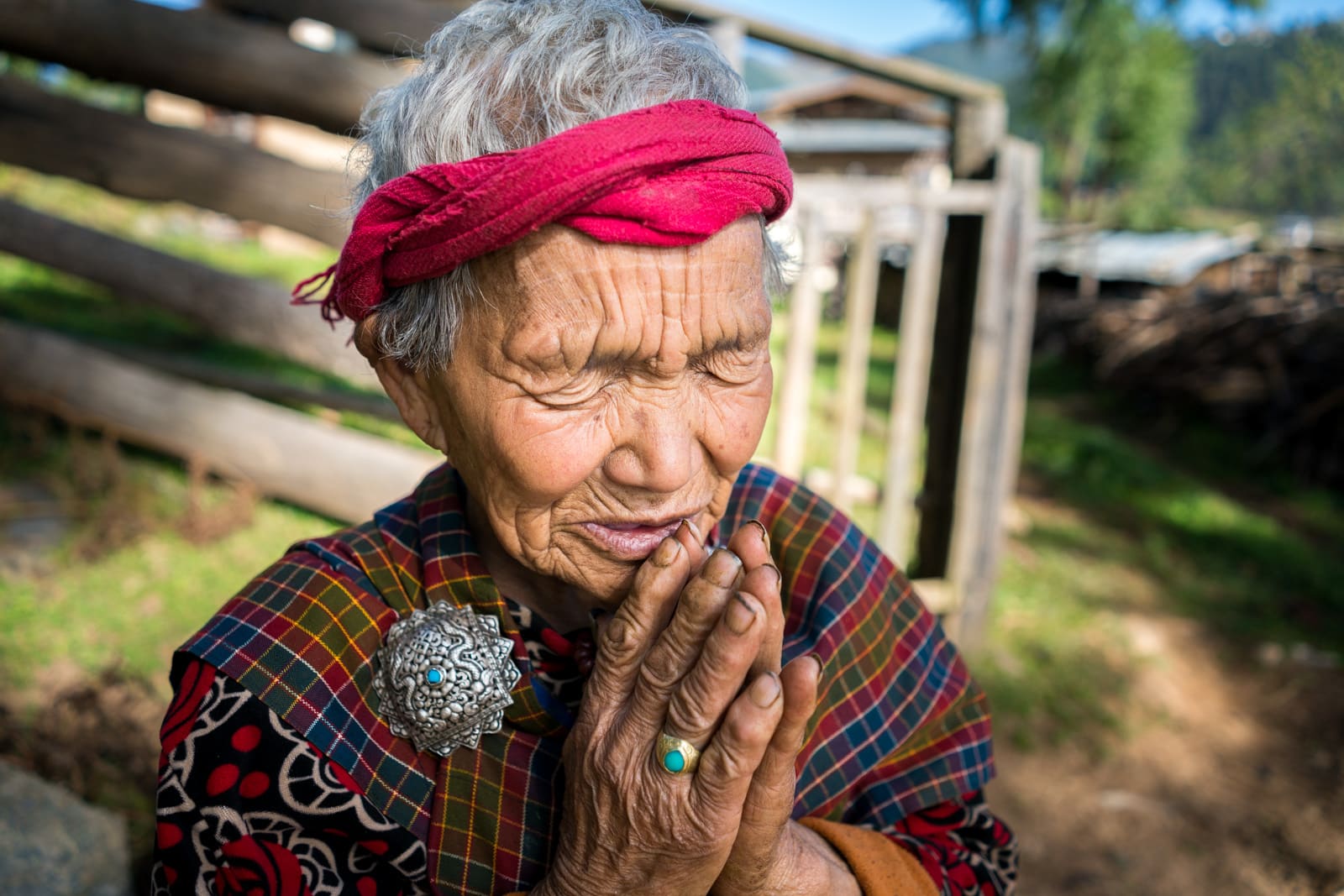 Stunning photos of Bhutan - Grandmother praying in Phobjikha Valley - Lost With Purpose travel blog