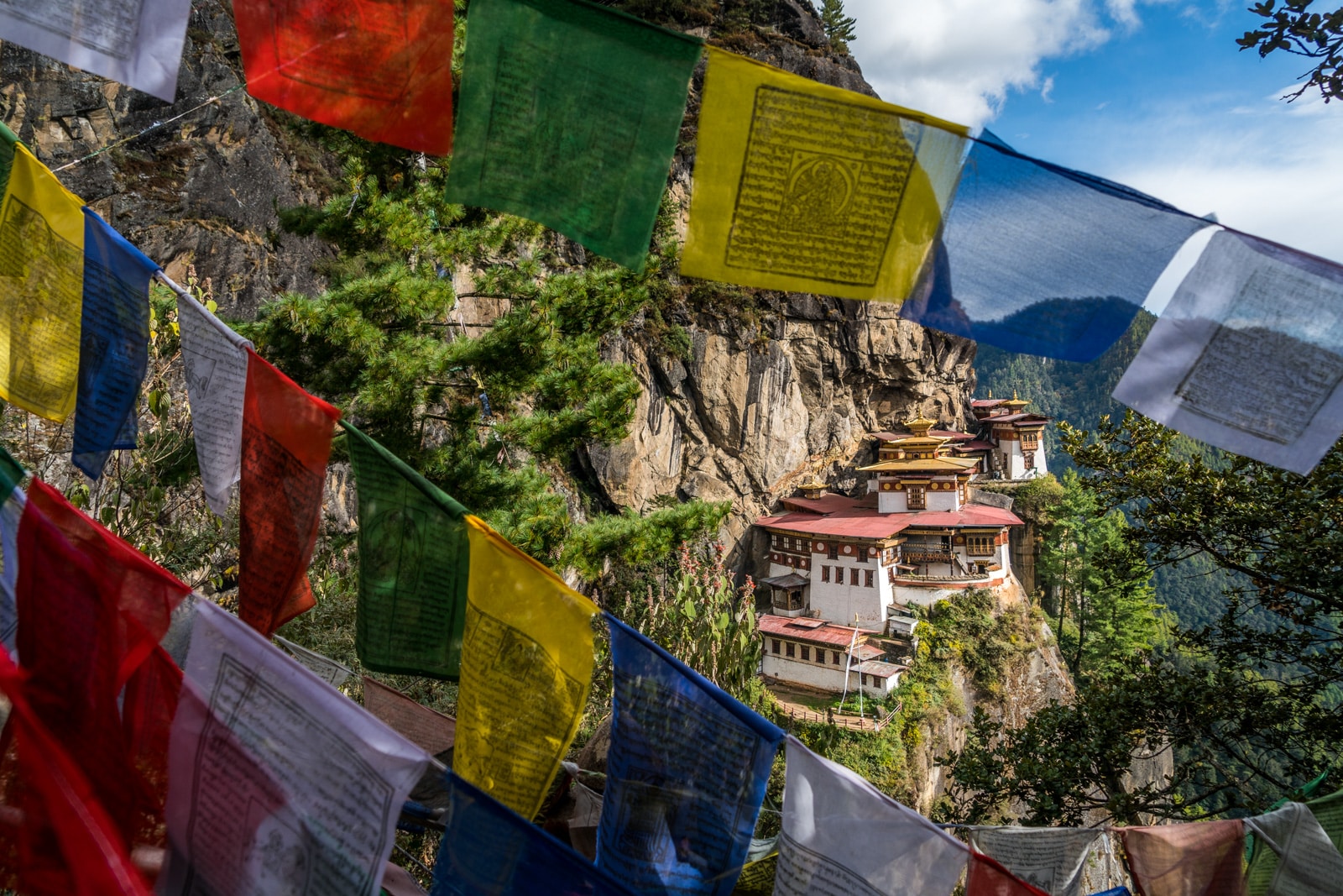 Photos of Bhutan - Tiger's Nest Monastery behind prayer flags - Lost With Purpose travel blog