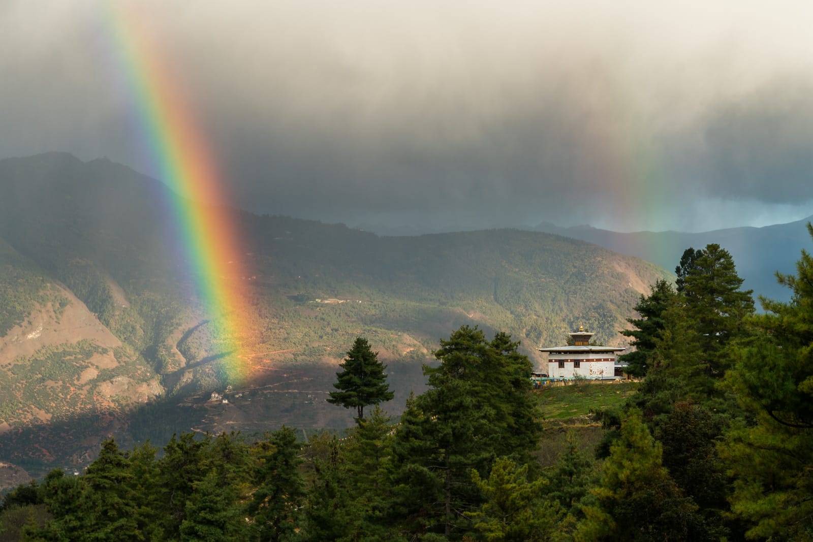 Photos of Bhutan - Double rainbow over a temple - Lost With Purpose travel blog