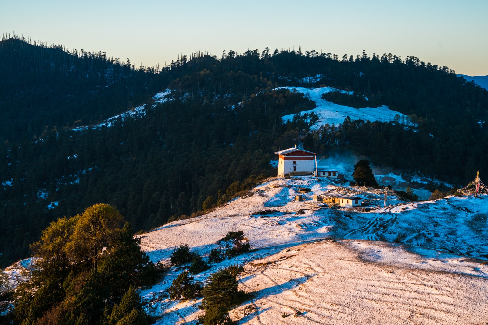 Photos of Bhutan - White snow at sunrise over Jele Dzong on the Druk Path - Lost With Purpose travel blog