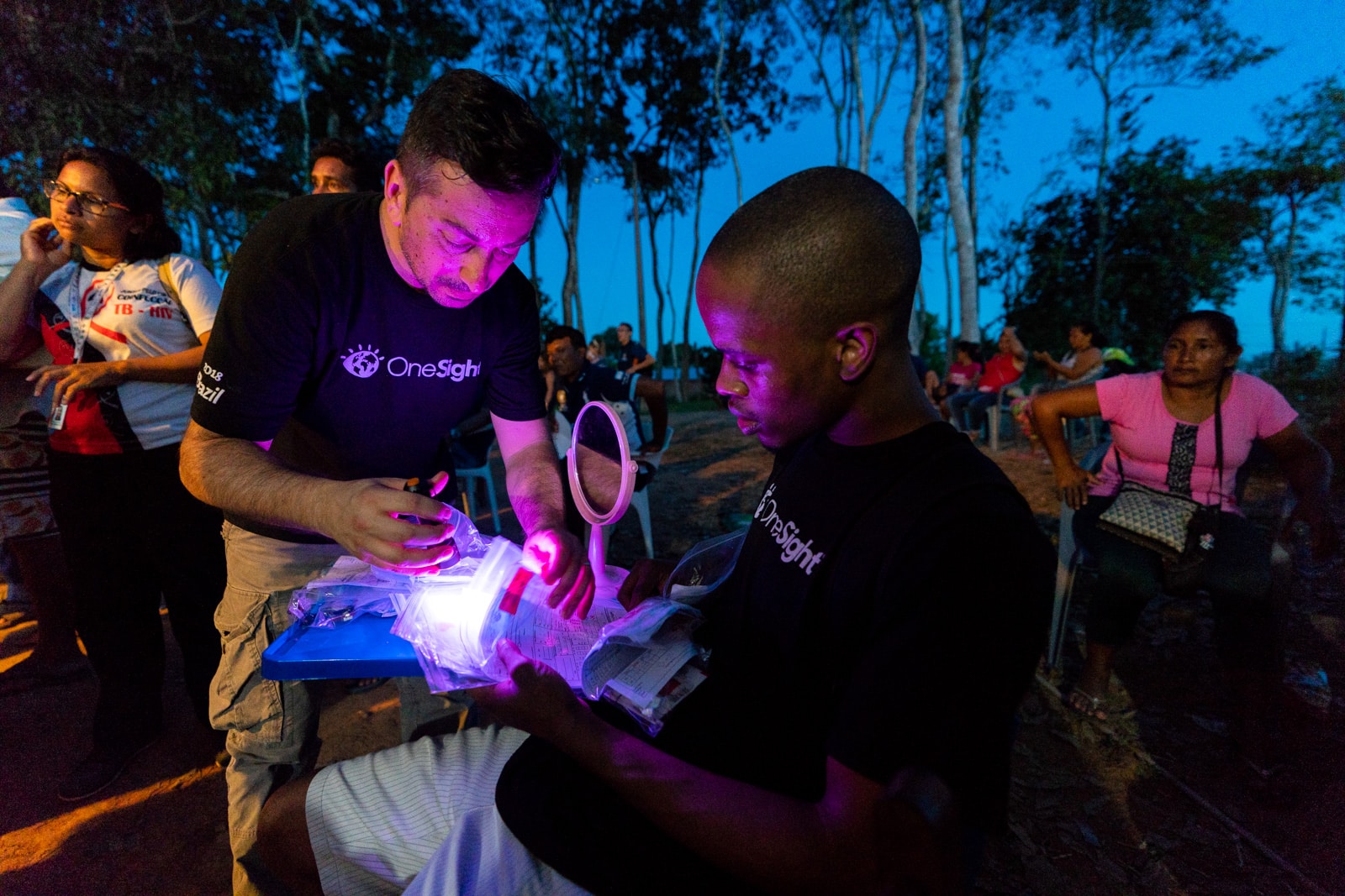 OneSight's mobile eye care clinic in the Brazilian Amazon - Volunteers sorting through glasses in the evening - Lost With Purpose travel blog