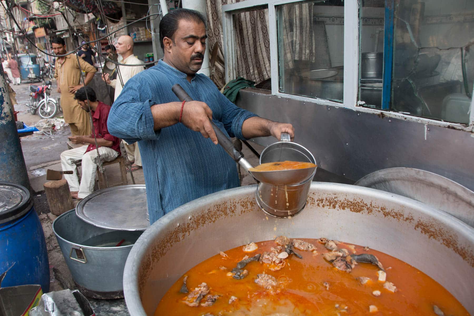 Pakistan bucket list - Man making soup in the walled city of Lahore - Lost With Purpose travel blog