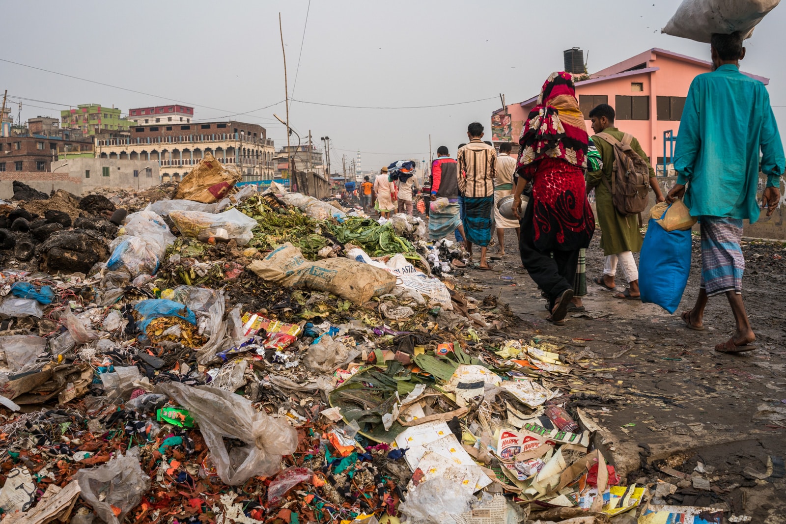 Reverse culture shock from long-term travel - Piles of trash on the streets of Dhaka, Bangladesh - Lost With Purpose travel blog