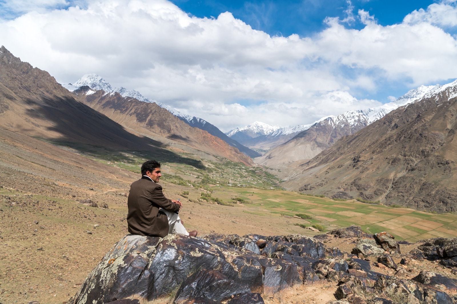 Phander Valley travel guide - Man sitting on a rock overlooking Teru - Lost With Purpose travel blog