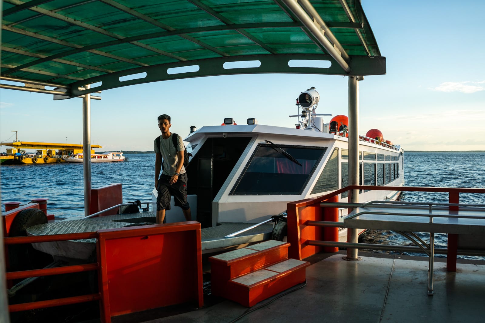 Taking the fast boat from Manaus, Brazil to Leticia, Colombia - Man getting off the fast boat at the terminal in Manaus - Lost With Purpose travel blog