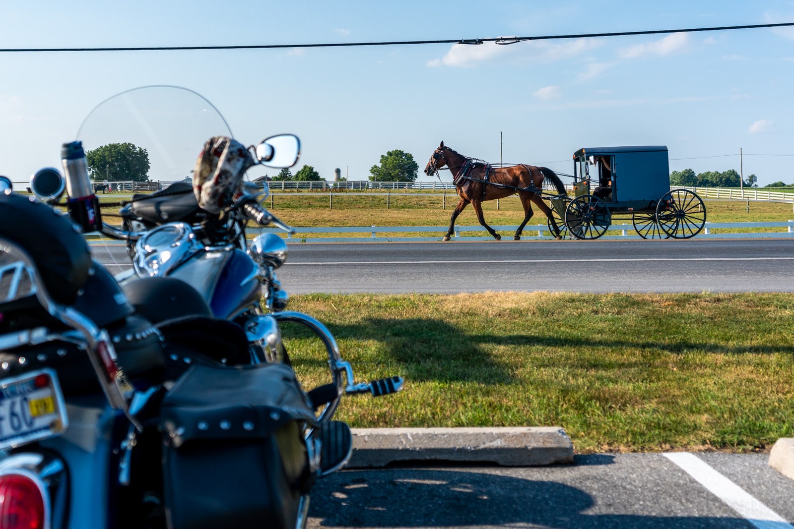 Reverse culture shock from long-term travel - Amish horse cart driving past a motorbike - Lost With Purpose travel blog