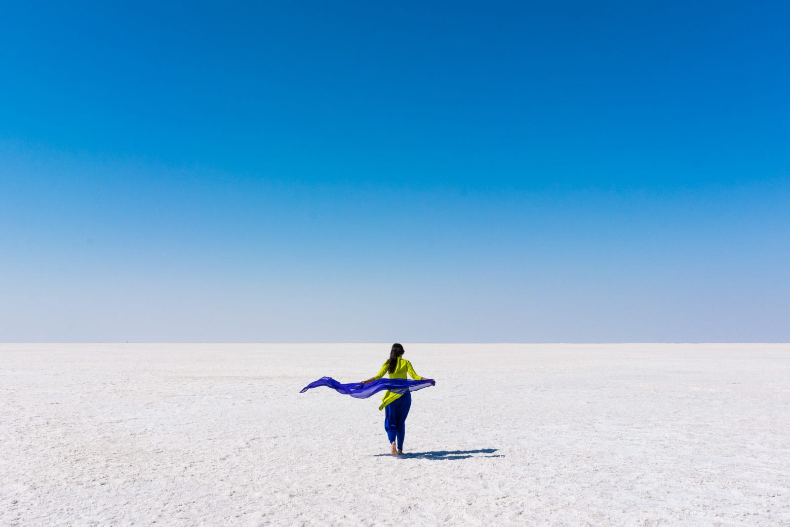 Reverse culture shock from long-term travel - Alex walking in the white desert known as the Great Rann of Kutch in Gujarat, India - Lost With Purpose travel blog