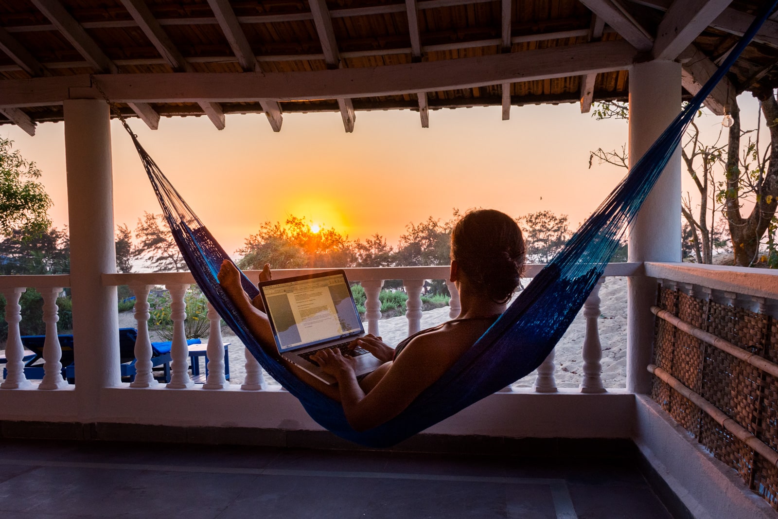 How I afford full-time travel - Working during sunset in Baga, Goa, India - Lost With Purpose travel blog