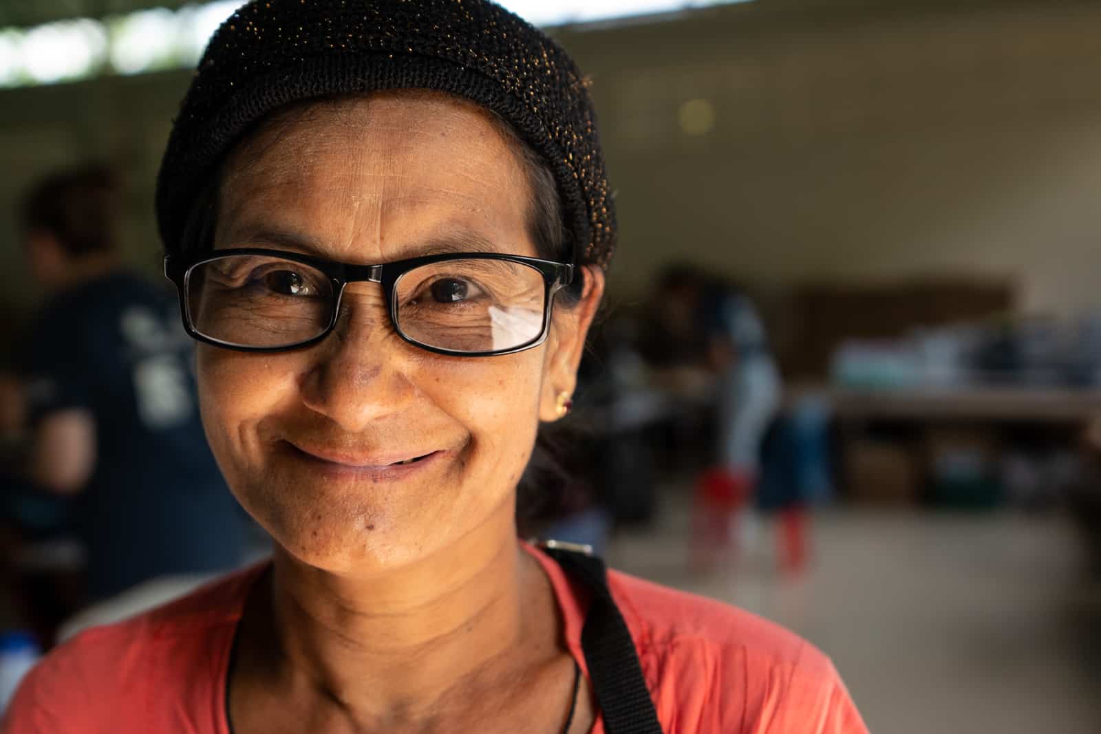 OneSight eye care clinic on the Thailand-Myanmar border - Woman with new glasses at Mae Tao Clinic - Lost With Purpose travel blog