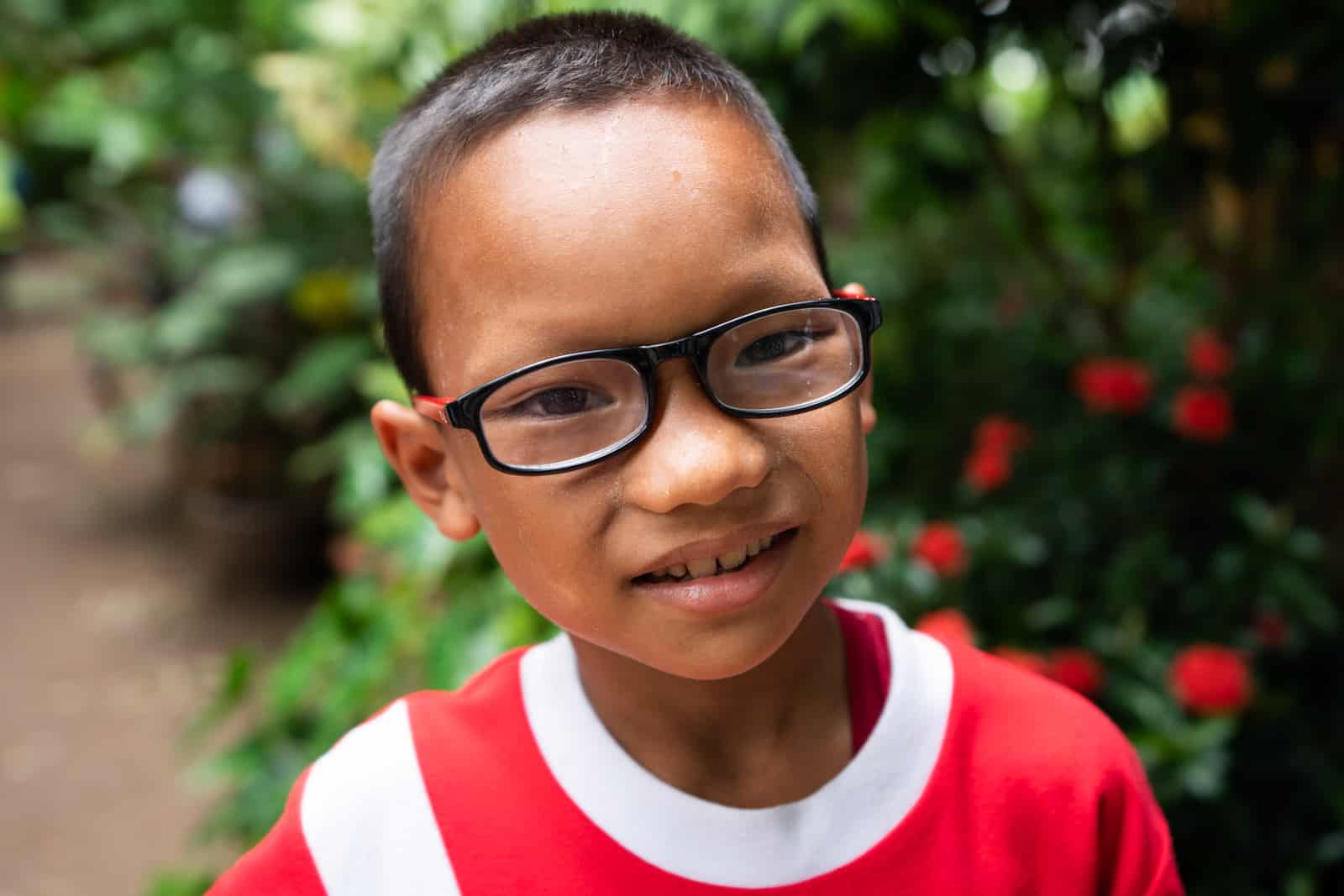 Eye clinic on the Thailand-Myanmar border - Young boy with glasses at the Mae Tao Clinic - Lost With Purpose travel blog