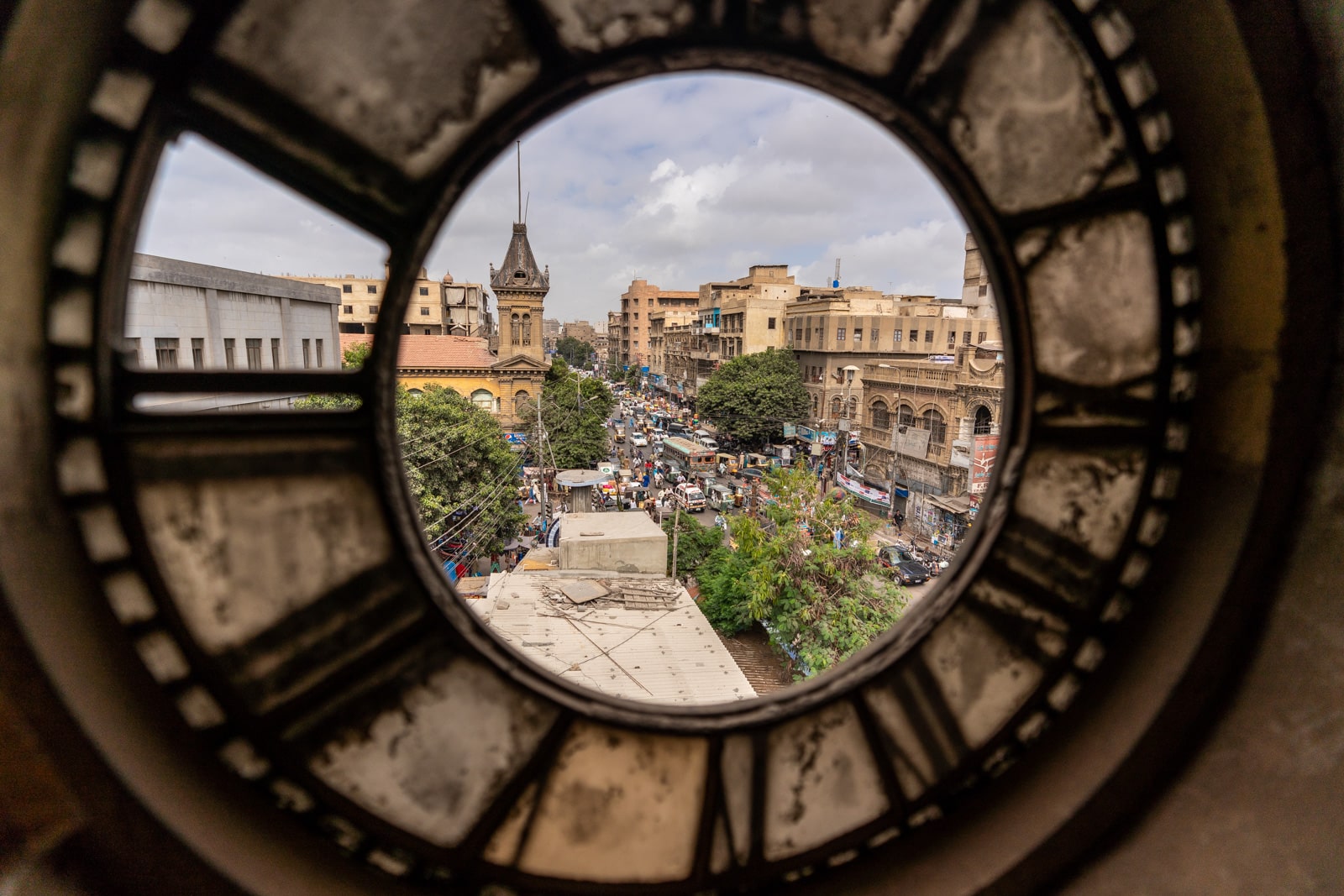 Ways of getting off the beaten track while traveling - View of Karachi through an old clock in Denso Hall - Lost With Purpose travel blog