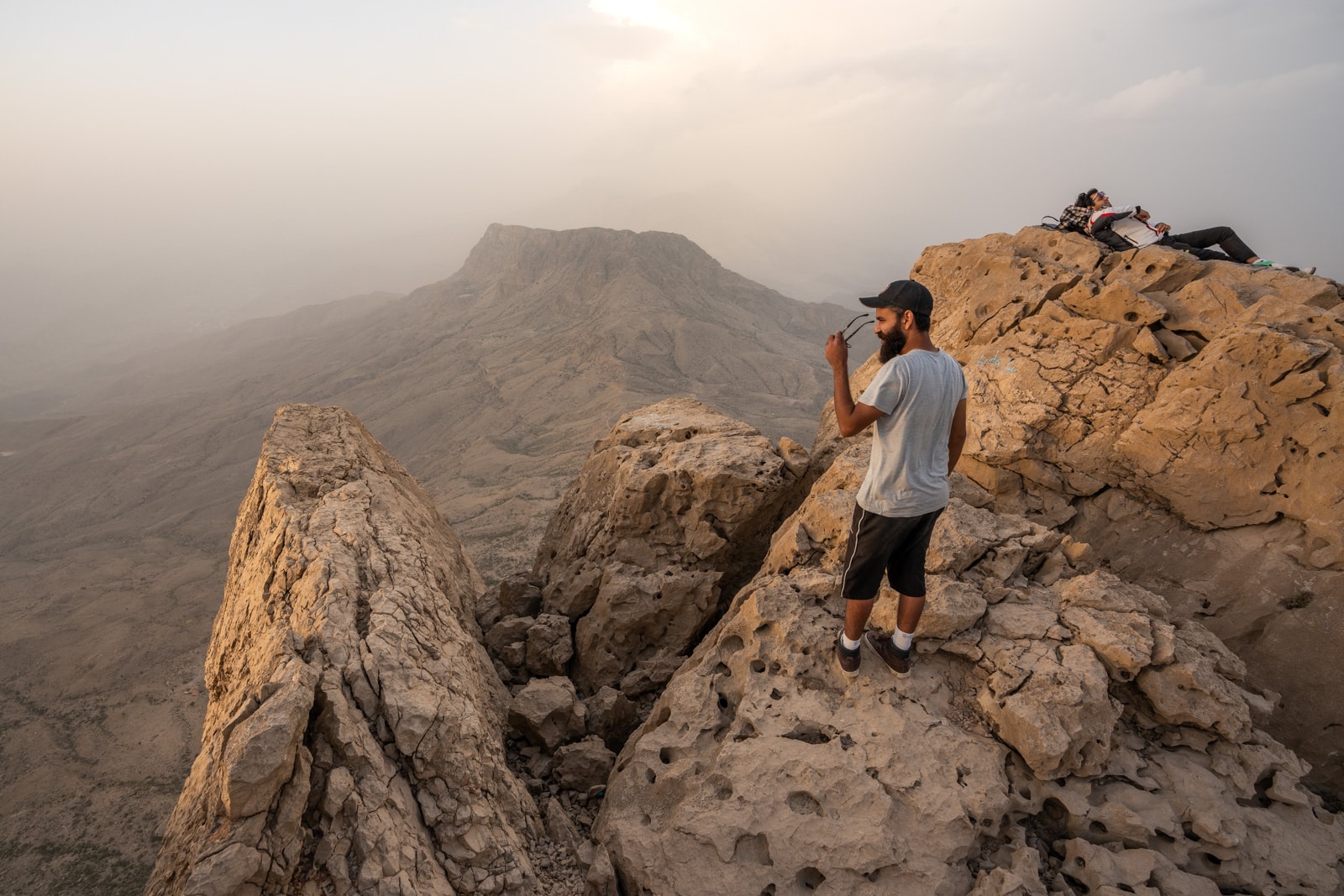 Reflections - Acid trip sunset over Gorakh Hill, Pakistan with boys on the rocks - Lost With Purpose travel blog