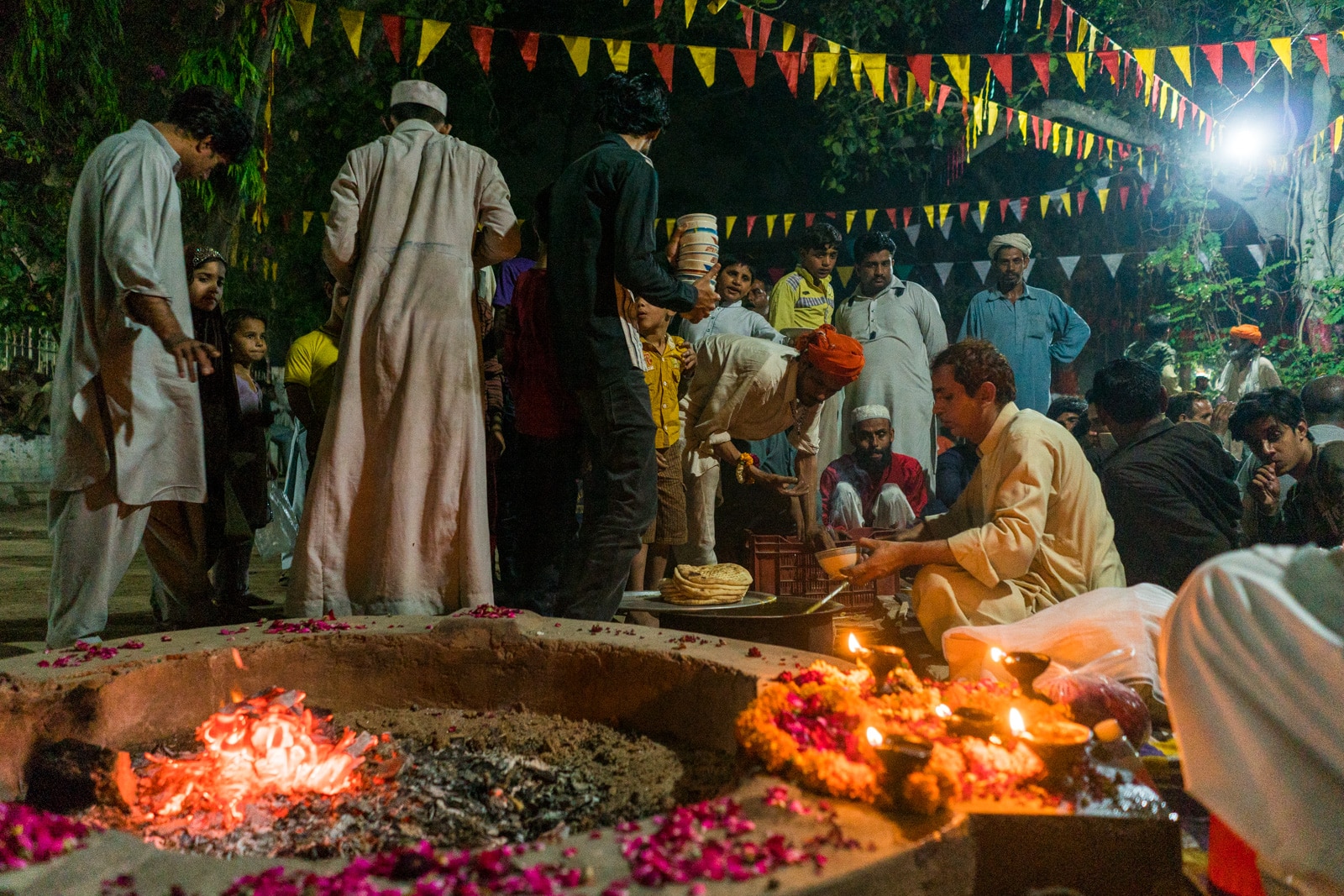 Sufi dhamal in Lahore, Pakistan - Man serving langar meal at the shrine of Madhu Lal Hussain - Lost With Purpose travel blog