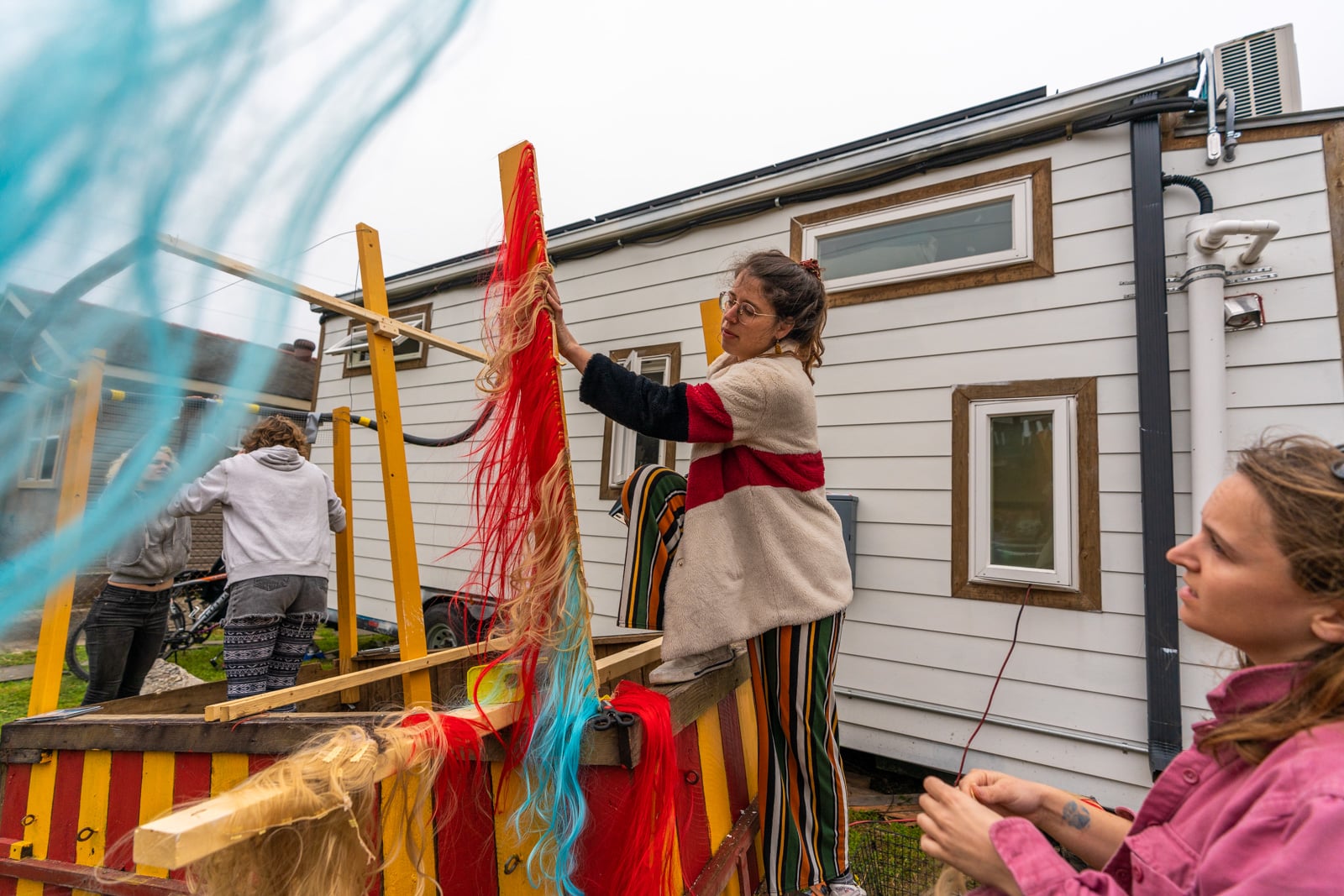 Putting dismantled wigs onto a Mardi Gras parade float in New Orleans