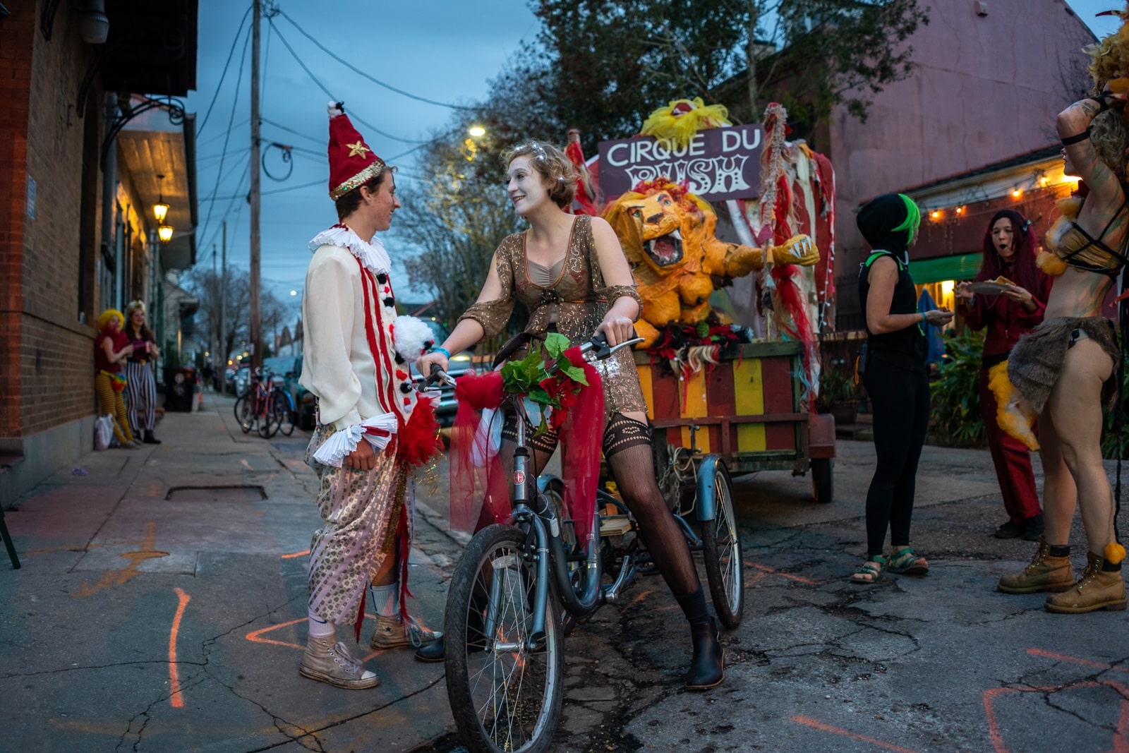 Paraders in circus costumes with a float during Mardi Gras in New Orleans