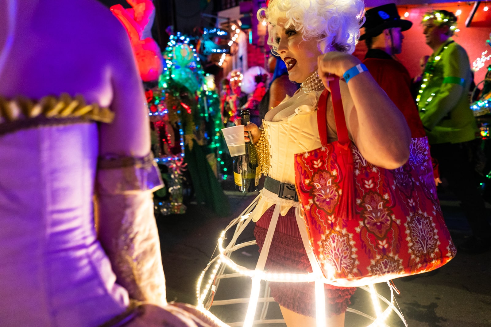 Woman in light up skirt drinking on the streets of New Orleans