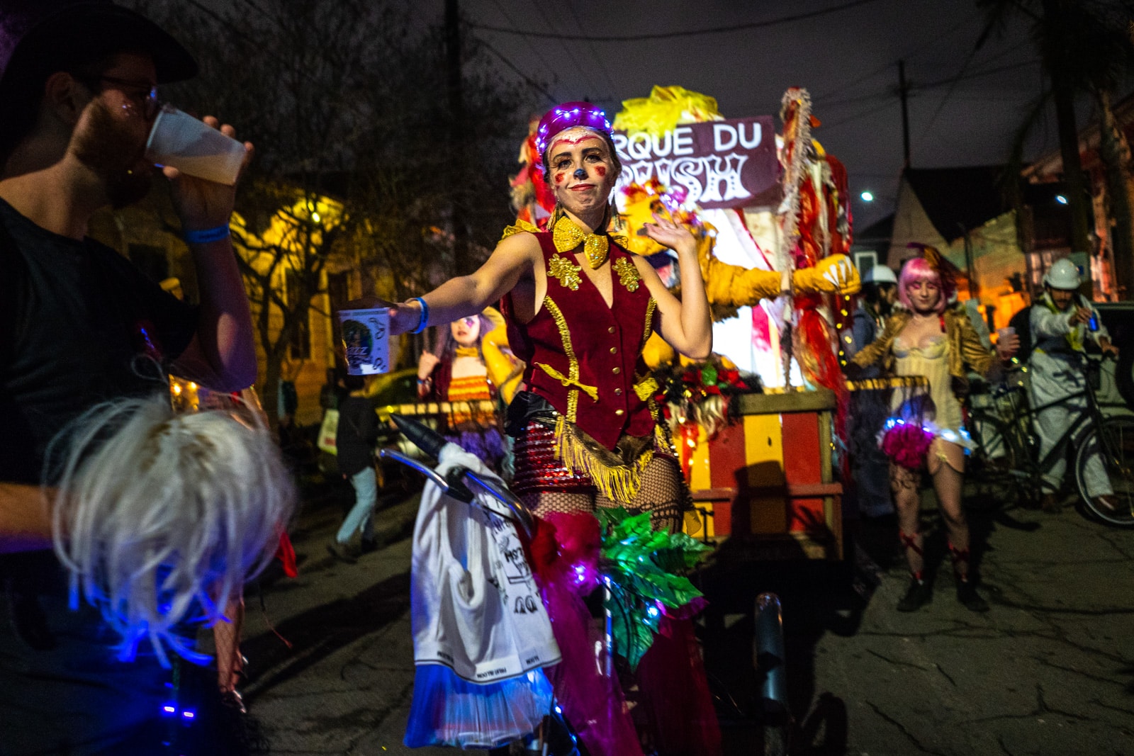 Girl cycling Krewe of Full Bush parade float in the Krewe Boheme Mardi Gras parade in New Orleans