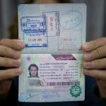 Man holding an Iranian tourist visa from Islamabad, Pakistan
