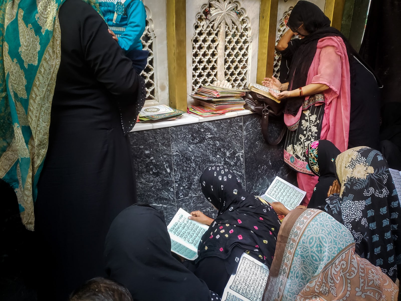 Interesting things to do in Lahore, Pakistan - Local women reading the Quran and praying at the shrine of Bibi Pak Daman