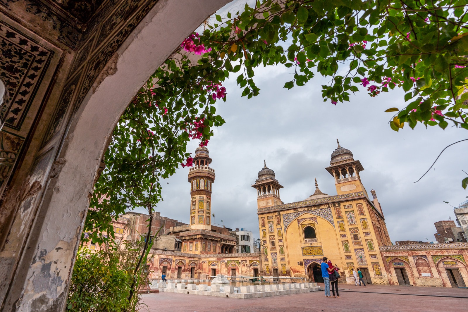 Wazir Khan mosque in Lahore through a flower lined archway