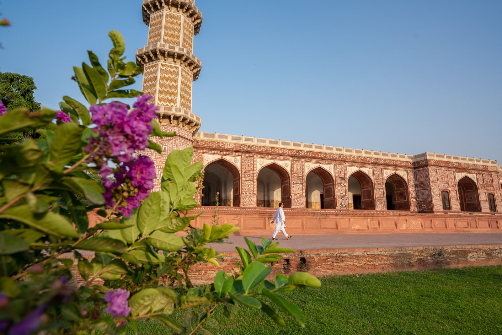 Day trips from Lahore, Pakistan - Man in a white salwar kameez walking at Jahangir's Tomb on the outskirts of Lahore