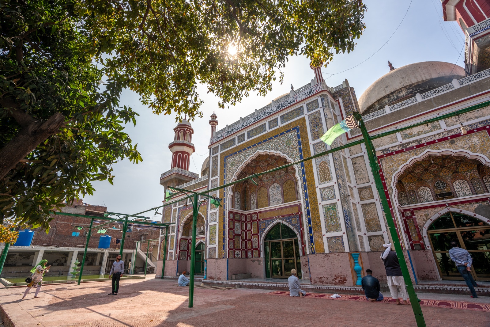 Interesting things to do in Lahore, Pakistan - Sunlight coming through trees at the Dai Anga Mosque in Lahore, Pakistan