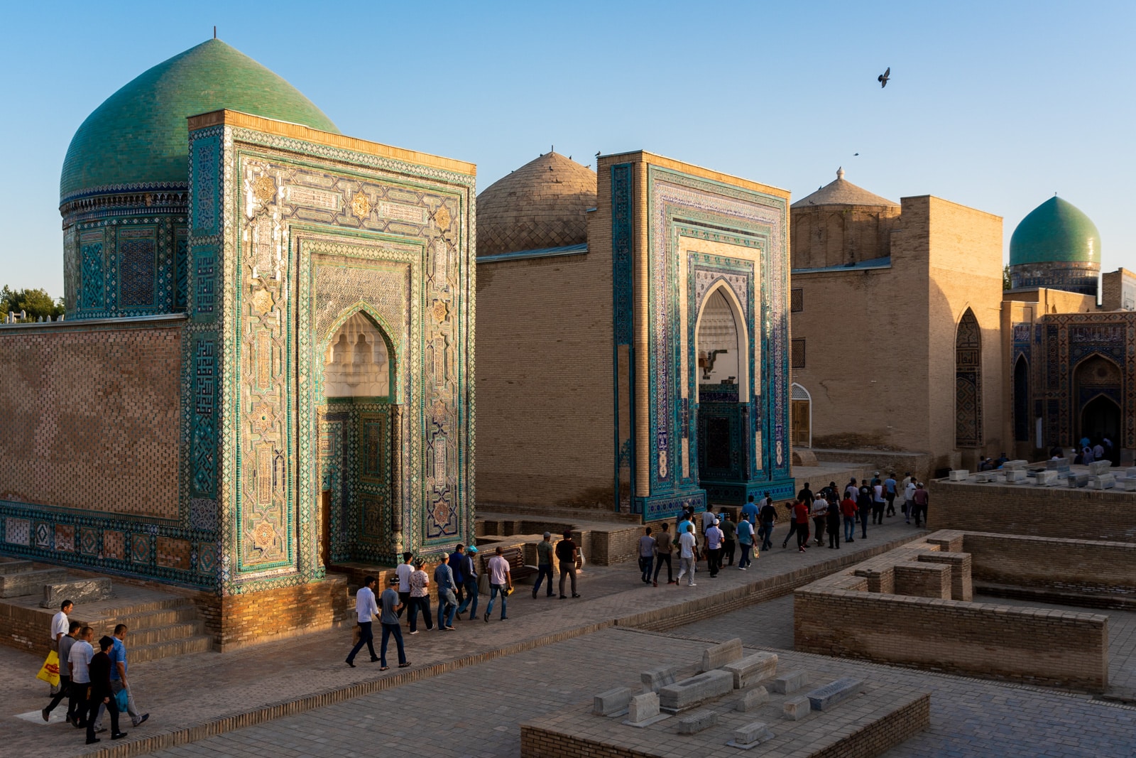 Men exiting the Shah i Zinda necropolis in Samarkand, Uzbekistan during Eid
