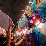 Krewe of Nyx parader blowing a kiss during Mardi Gras in New Orleans