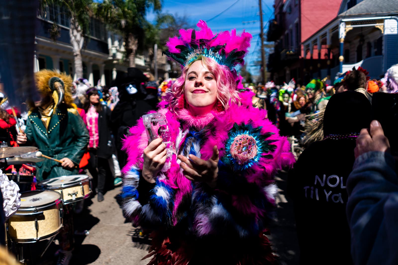 Girl with pink hair parading on Mardi Gras day