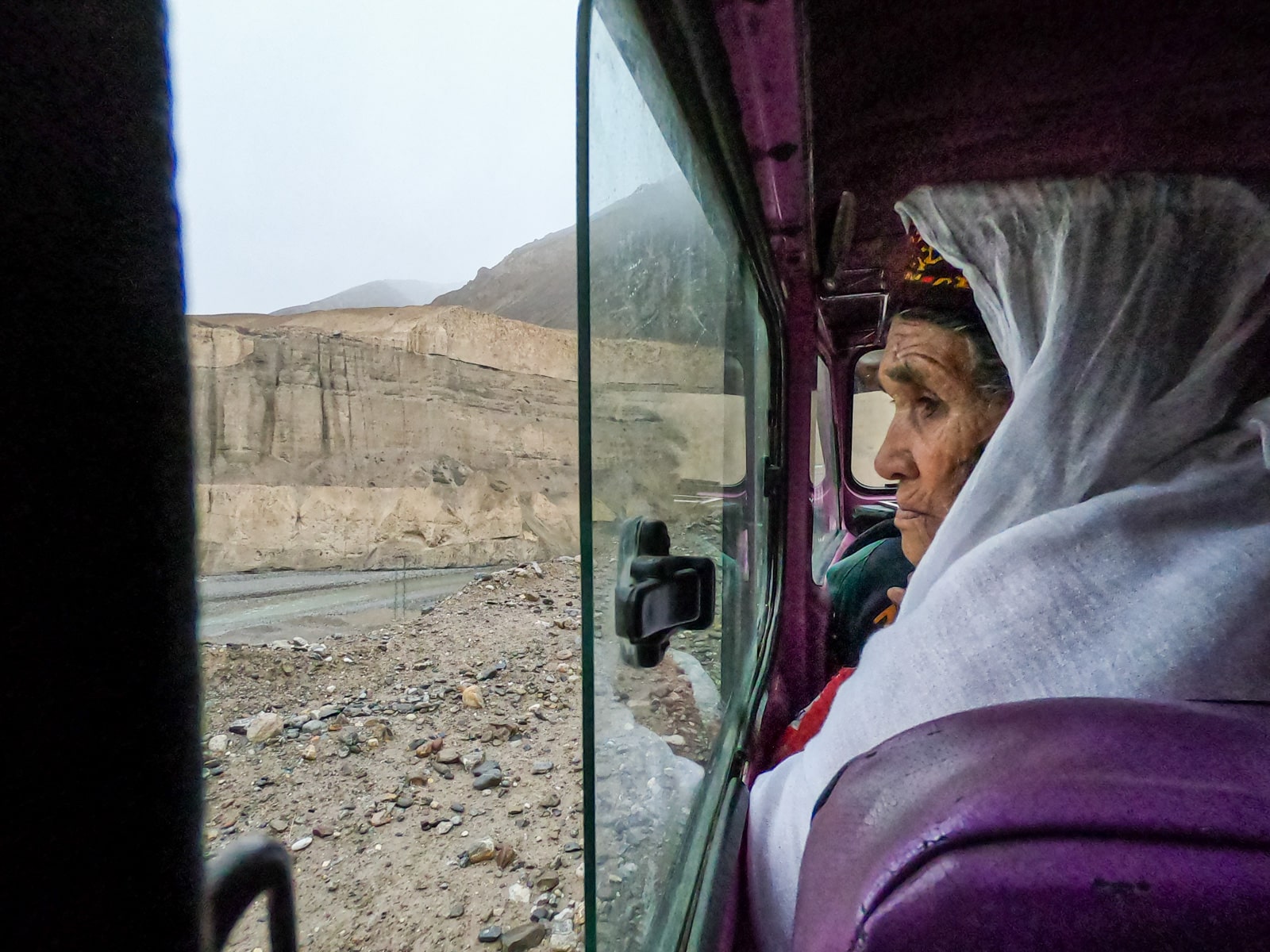 Old woman looking out the window in the jeep to Chapursan Valley