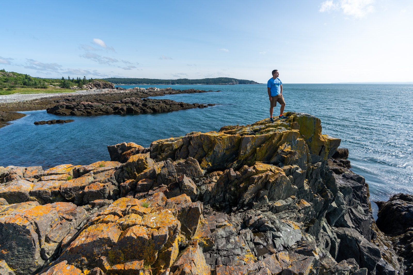 Brother standing on rocks on the Bold Coast near Lubec, Maine