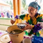 Woman serving soup in Khorog, Tajikistan