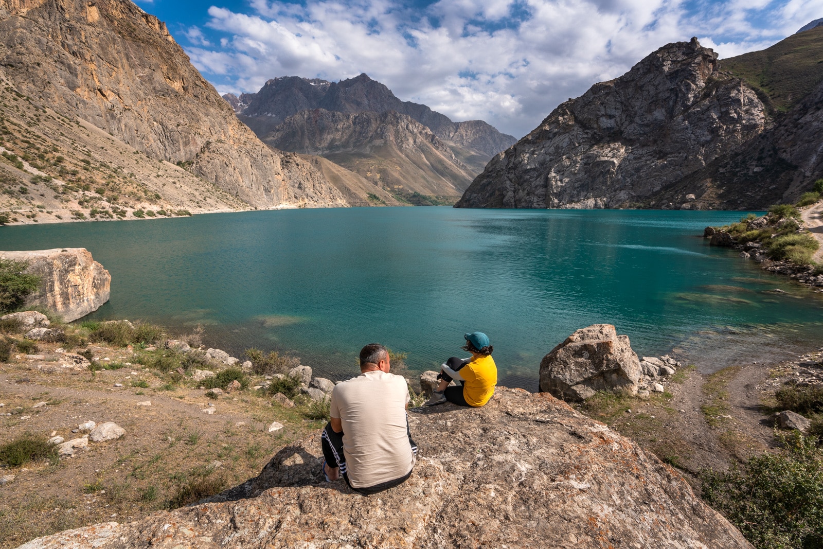 People sitting by one of the Haft Kol in Tajikistan