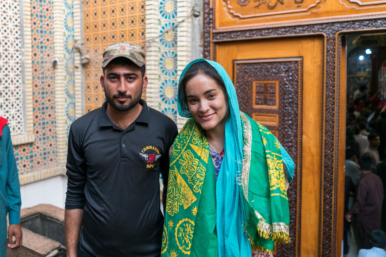 Female traveler with a security escort in Sehwan Sharif, Pakistan