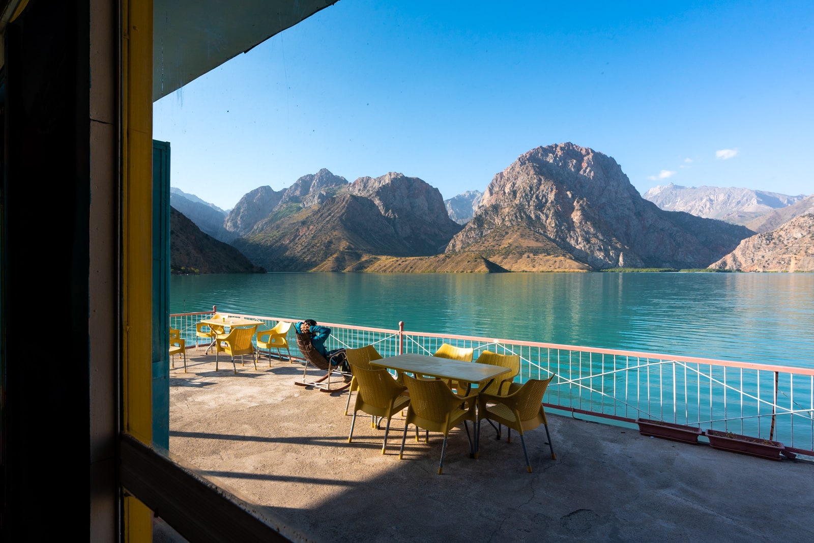 Person relaxing by Iskanderkul Lake in Tajikistan