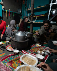 Female travelers enjoying food at a local homestay in Yasin, Pakistan