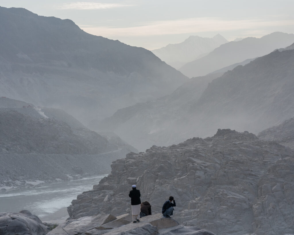 Men sitting by the Karakoram Highway in the mountains near Chilas, Pakistan