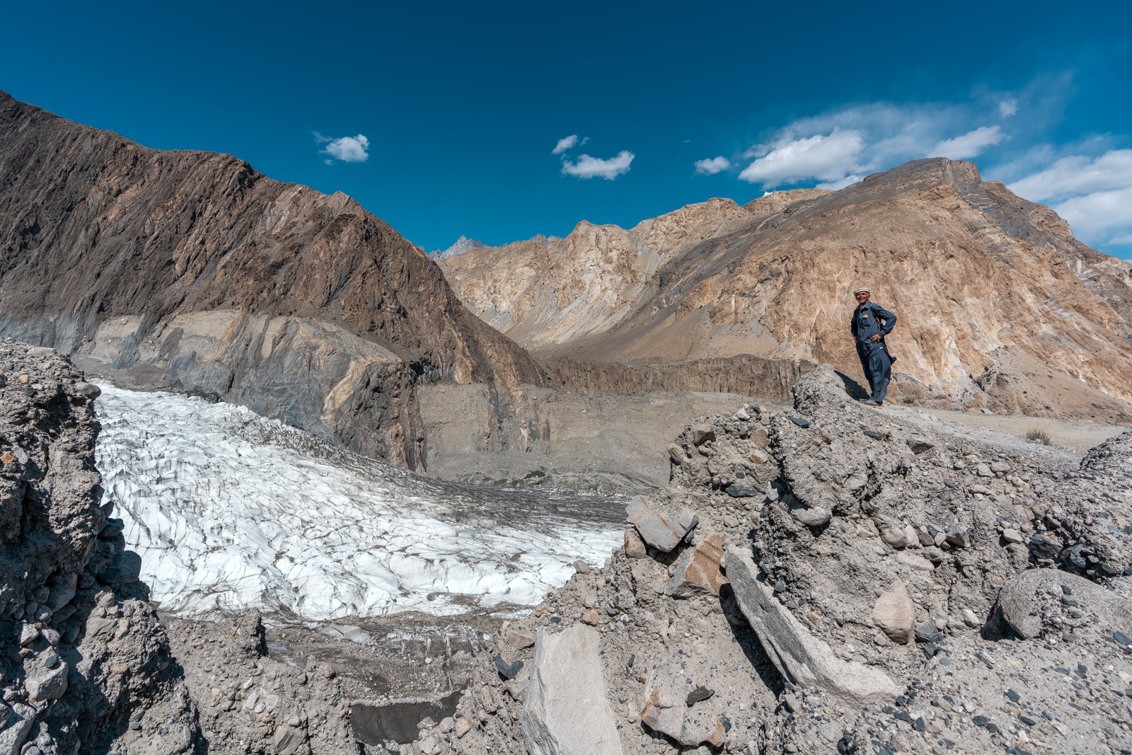 Local man standing by the White Passu Glacier in Gojal, Pakistan