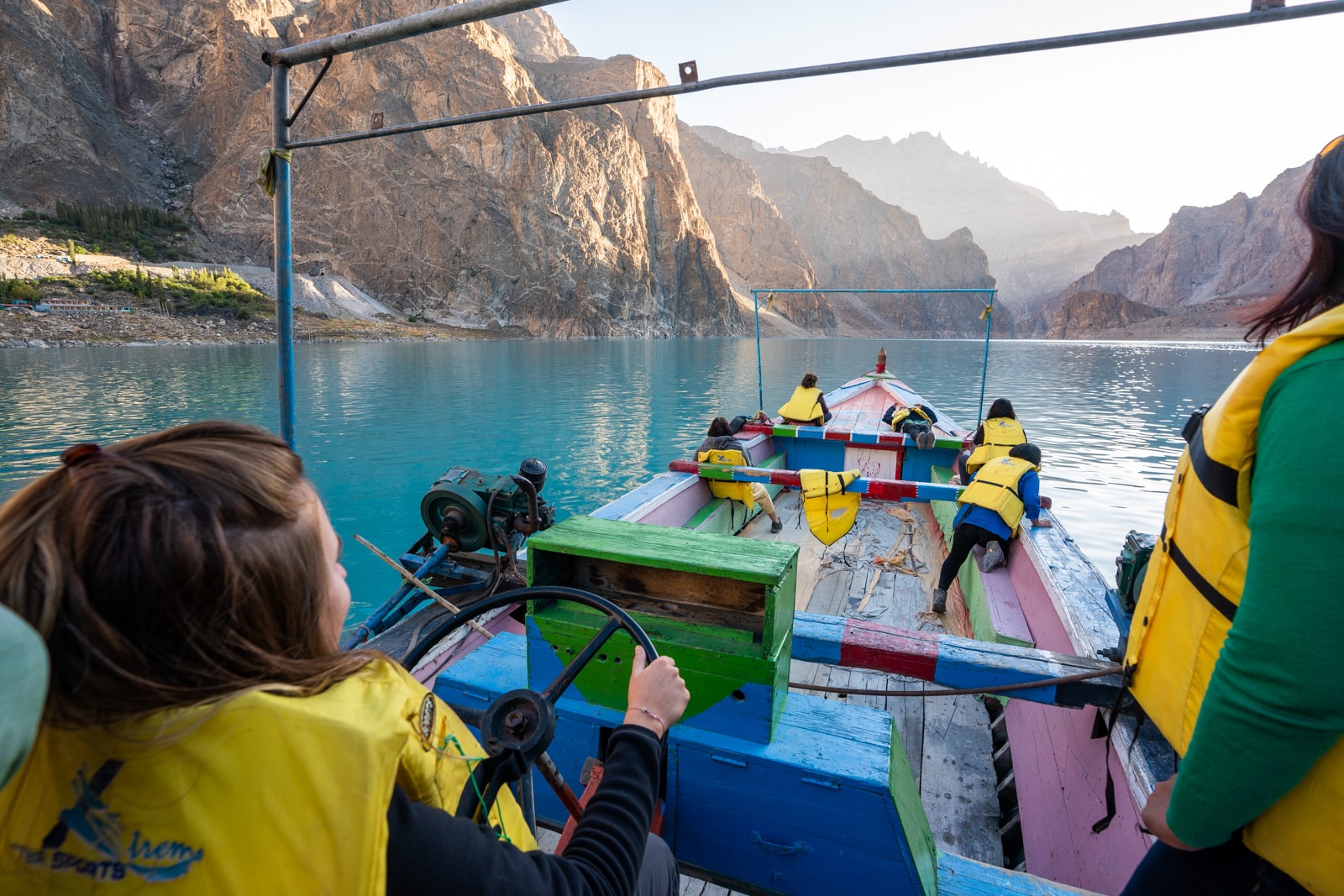 Female travel group boating across Attabad Lake, Gilgit Baltistan, Pakistan
