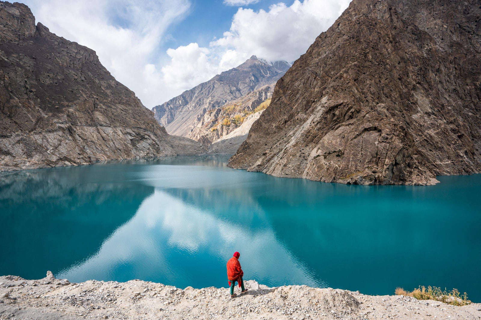 Woman standing by Attabad Lake in Gilgit Baltistan, Pakistan