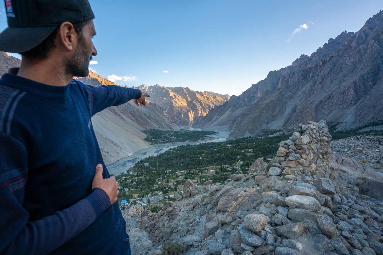 Man pointing at Gulmit Village in Gilgit Baltistan, Pakistan