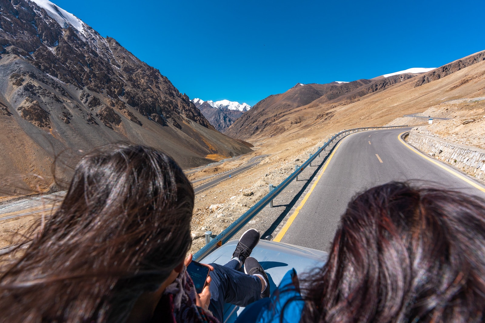 Girls riding on top of a bus to Khunjerab Pass, Pakistan