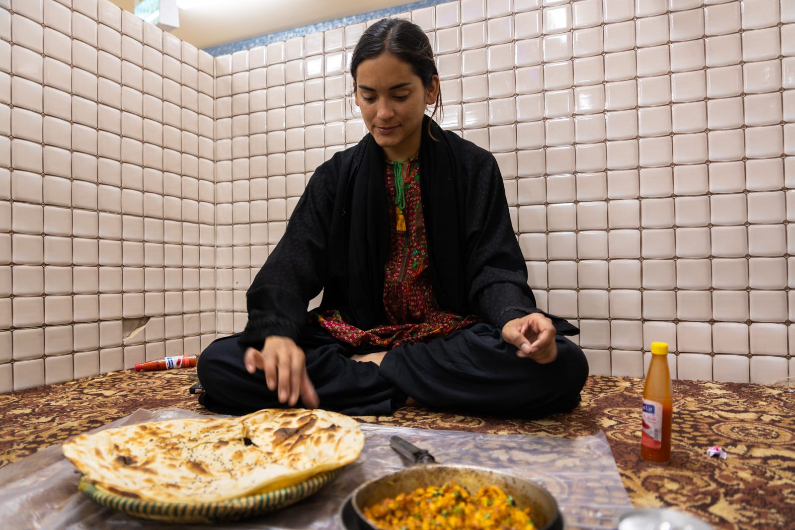 Female traveler eating in a family section of a Saudi Arabia restaurant