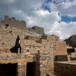 Female traveler in Saudi Arabia standing in Dhee Ayn marble village in Al Baha region