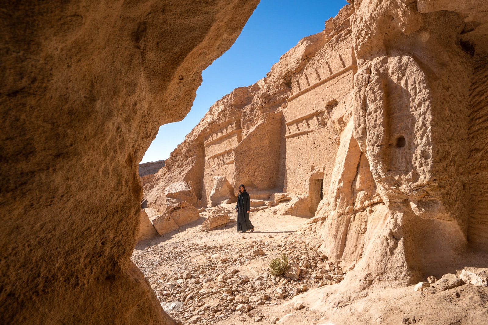 Female traveler walking in Nabatean tombs in Al Bad', Saudi Arabia