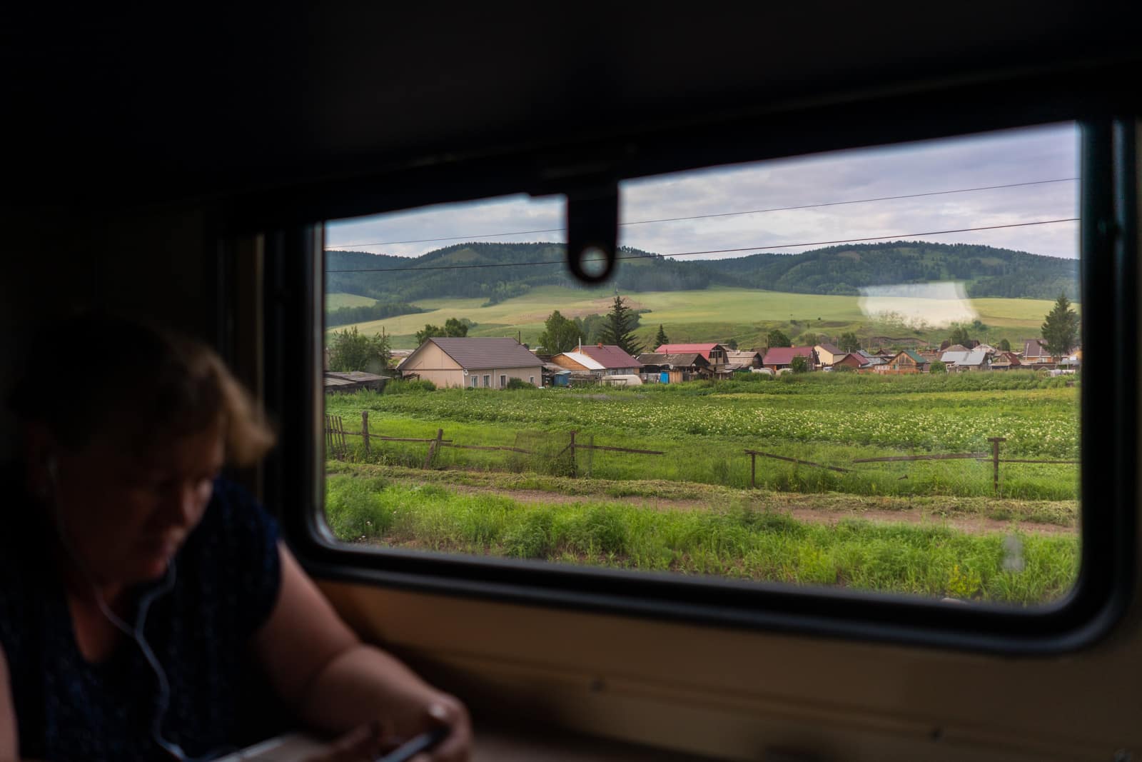 Siberian cottages and landscape from train window in Russia