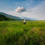 Solo female traveler walking in marshes in northern Lake Baikal, Siberia, Russia