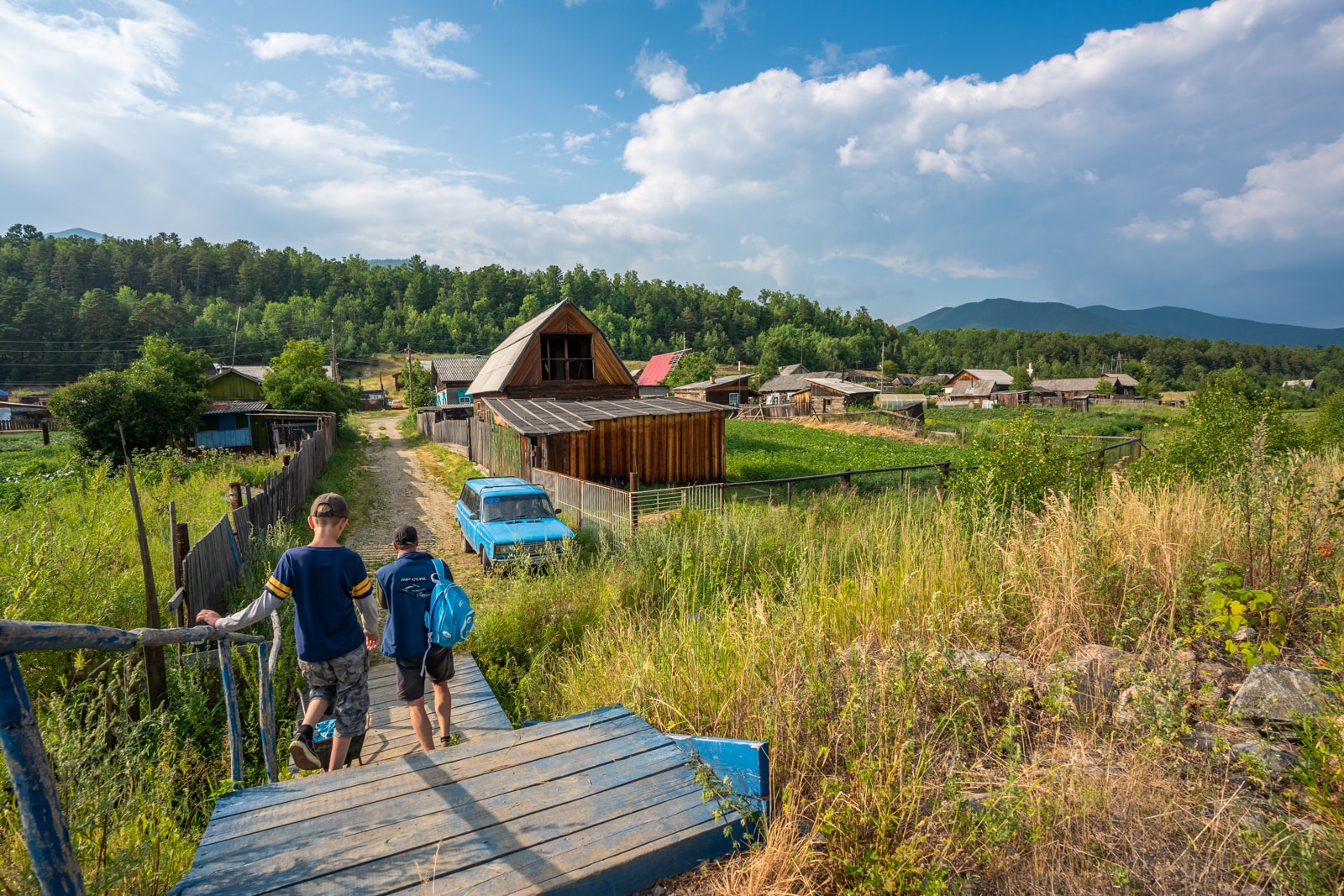 Father and son walking in Dushkachan village near Severobaikalsk, Siberia, Russia