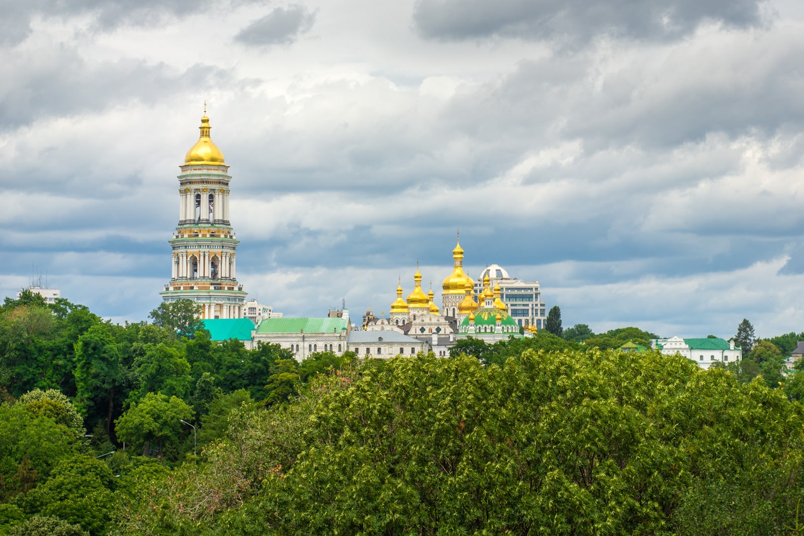 View of Kiev Pechersk Lavra cave monastery through trees in Kyiv, Ukraine